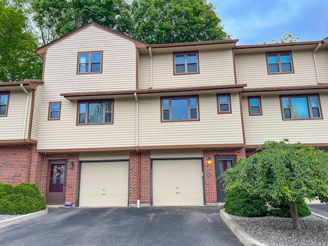 1516 E Main St Apt 18, Meriden, CT 06450 - multi unit property with driveway, an attached garage, and brick siding