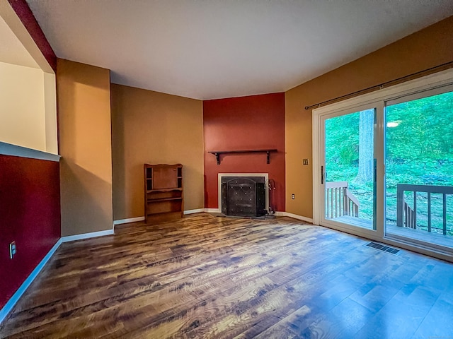 1516 E Main St Apt 18, Meriden, CT 06450 - unfurnished living room with a fireplace, wood finished floors, and baseboards