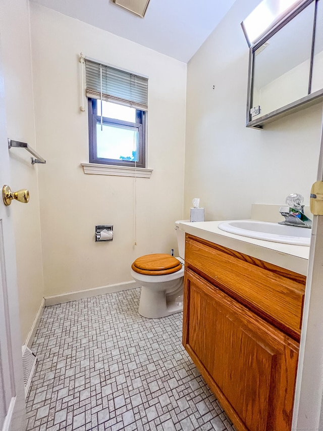 1516 E Main St Apt 18, Meriden, CT 06450 - half bath with vanity, toilet, baseboards, and brick patterned floors