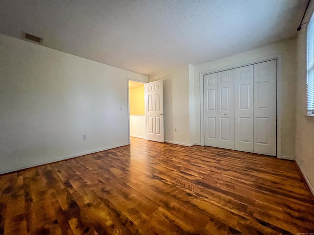 1516 E Main St Apt 18, Meriden, CT 06450 - unfurnished bedroom with wood finished floors, baseboards, and a closet