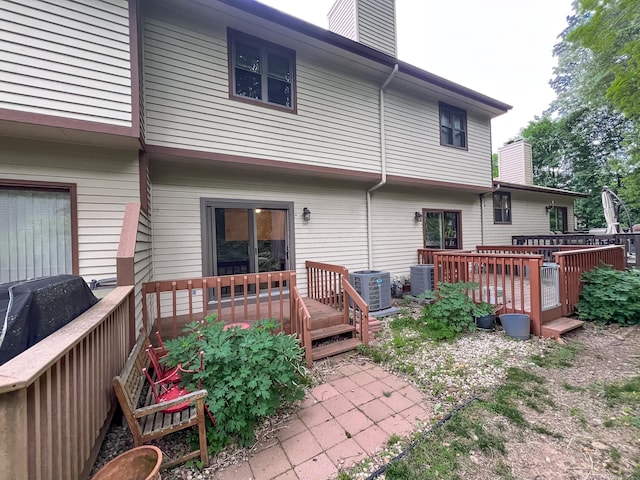 1516 E Main St Apt 18, Meriden, CT 06450 - back of property with a chimney, a deck, and central AC