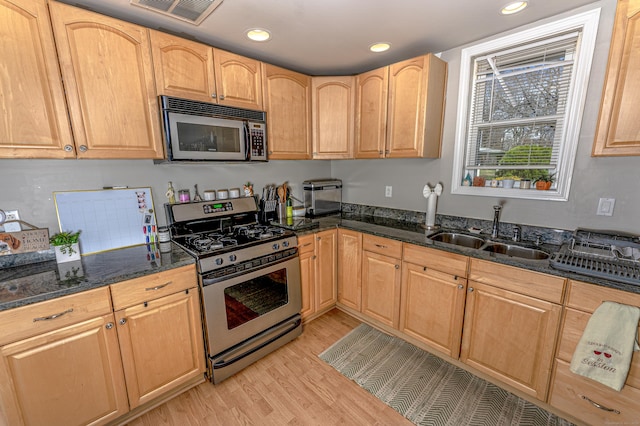 188 Meadow St, Branford, CT 06405 - kitchen featuring light wood-style flooring, visible vents, dark stone counters, stainless steel appliances, and a sink