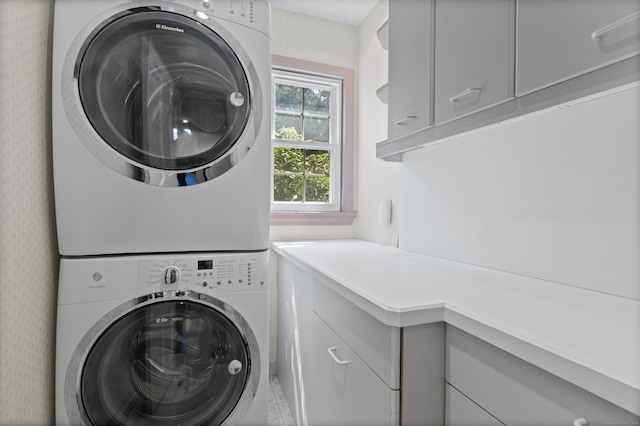 15 Maple Ln, Brookfield, CT 06804 - washroom with stacked washer / dryer, cabinet space, and wallpapered walls
