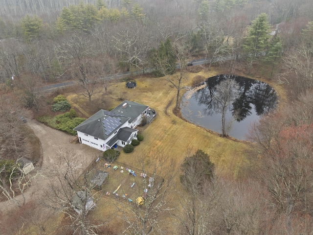 drone / aerial view with a view of trees and a water view