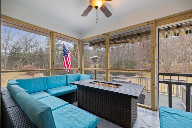 sunroom / solarium with an outdoor living space with a fire pit and ceiling fan