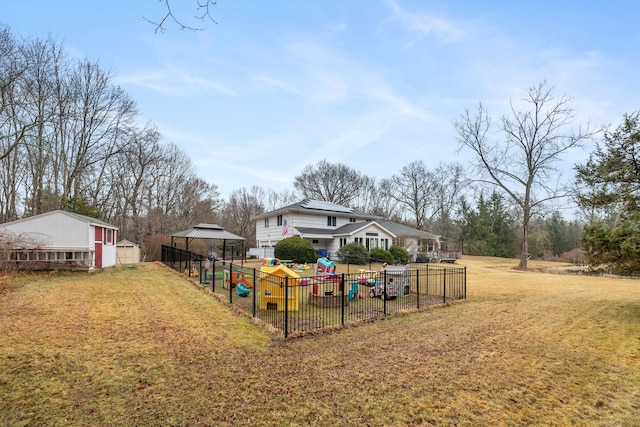 view of yard with an outdoor structure, fence, a shed, and a gazebo