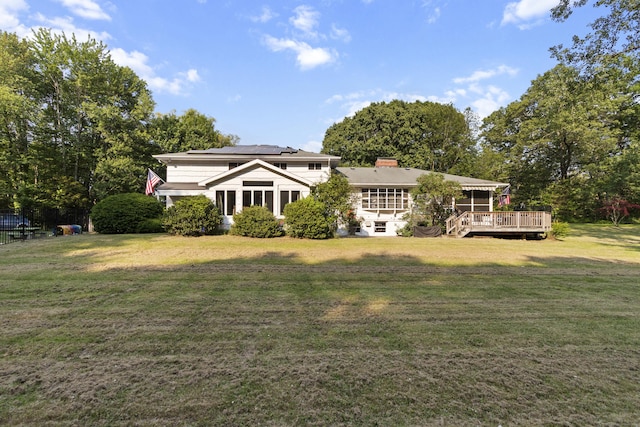 47 Notch Rd, Simsbury, CT 06092 - view of front of home with solar panels, a wooden deck, a front yard, and a chimney