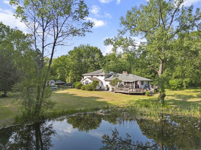 47 Notch Rd, Simsbury, CT 06092 - back of house with a deck with water view, a yard, and a chimney