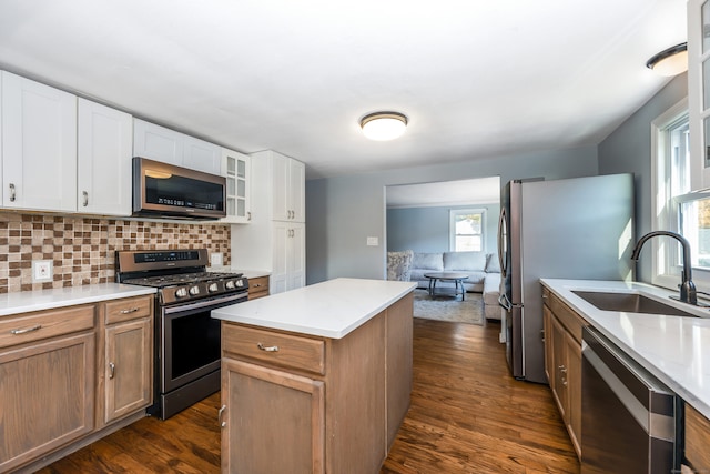 66 Waterview Dr, Newtown, CT 06482 - kitchen featuring appliances with stainless steel finishes, a sink, a center island, dark wood finished floors, and backsplash