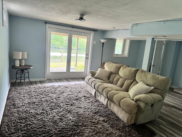 66 Waterview Dr, Newtown, CT 06482 - living room featuring wood finished floors, a textured ceiling, and baseboards