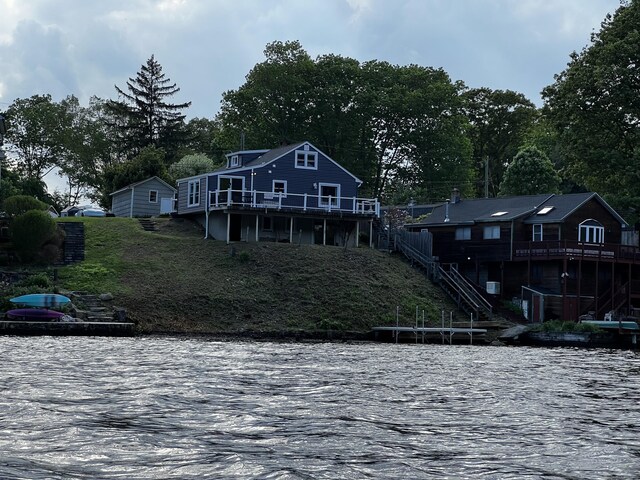 66 Waterview Dr, Newtown, CT 06482 - back of property with stairs, a deck with water view, and view of scattered trees