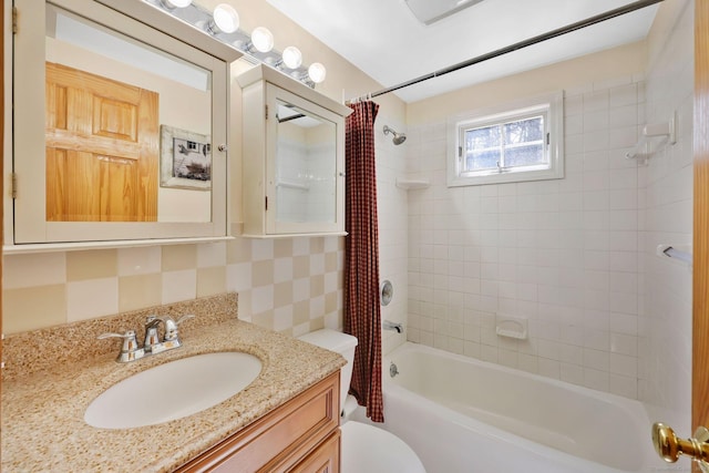 bathroom with toilet, shower / tub combo with curtain, and vanity