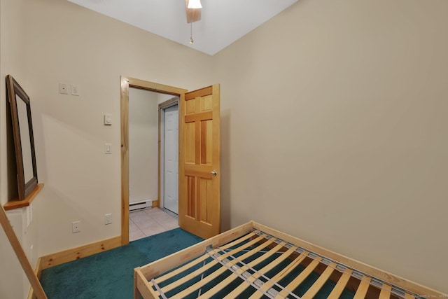 unfurnished bedroom with baseboards, a baseboard heating unit, and a ceiling fan