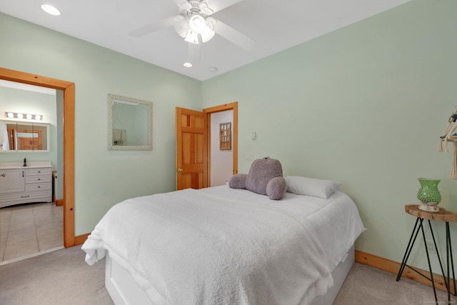 bedroom featuring ensuite bath, baseboards, light colored carpet, and recessed lighting