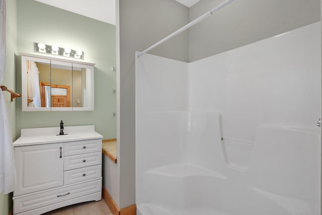 bathroom featuring vanity, tile patterned floors, and walk in shower