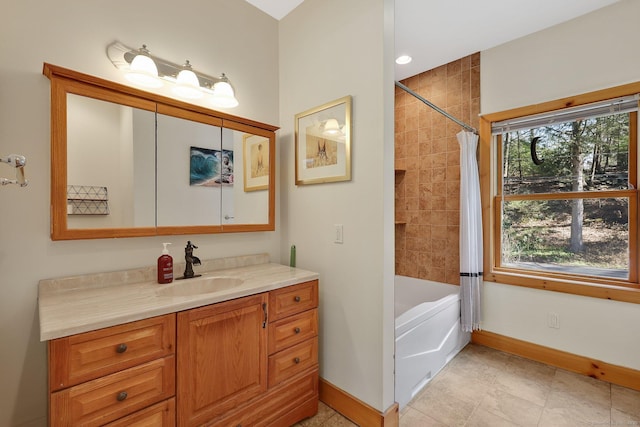 full bath featuring baseboards, shower / bath combo with shower curtain, and vanity