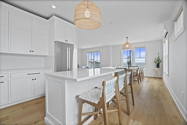 185 Main St Apt 301, East Lyme, CT 06357 - kitchen featuring high end fridge, light wood-style flooring, and white cabinets