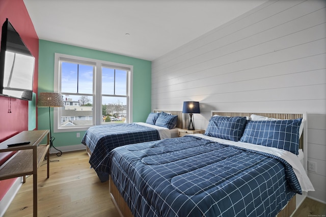 185 Main St Apt 301, East Lyme, CT 06357 - bedroom with baseboards, wood walls, and wood finished floors