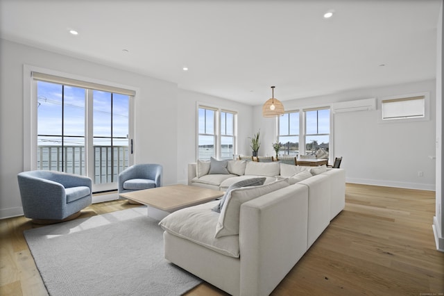 185 Main St Apt 301, East Lyme, CT 06357 - living area with recessed lighting, baseboards, light wood-style flooring, and a wall mounted air conditioner