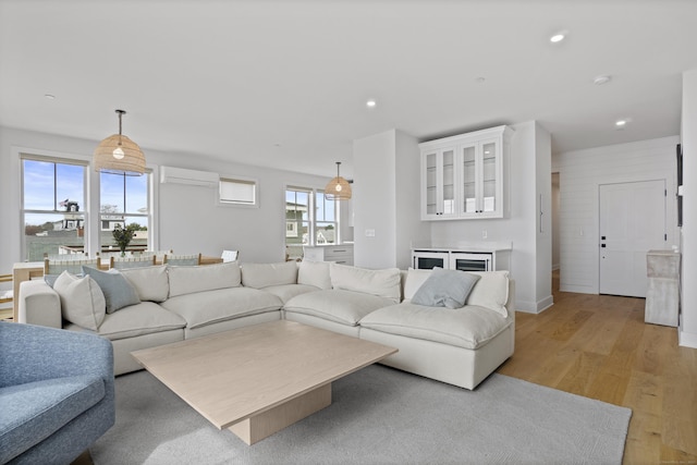 185 Main St Apt 301, East Lyme, CT 06357 - living room featuring light wood-style floors, baseboards, recessed lighting, and a wall mounted air conditioner