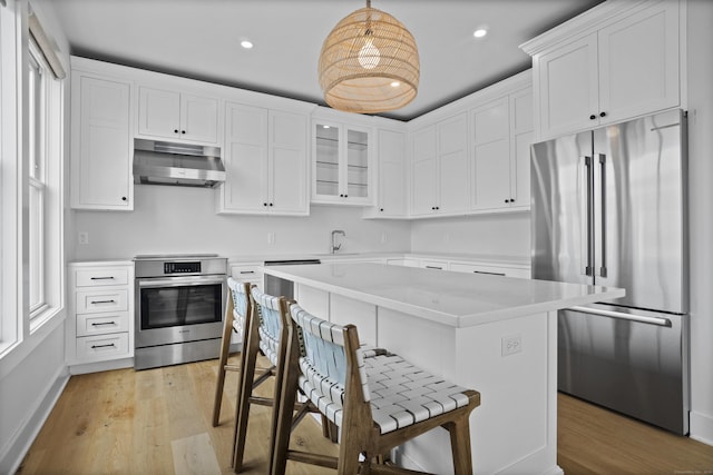 185 Main St Apt 301, East Lyme, CT 06357 - kitchen featuring light wood finished floors, light countertops, range, high end refrigerator, and under cabinet range hood