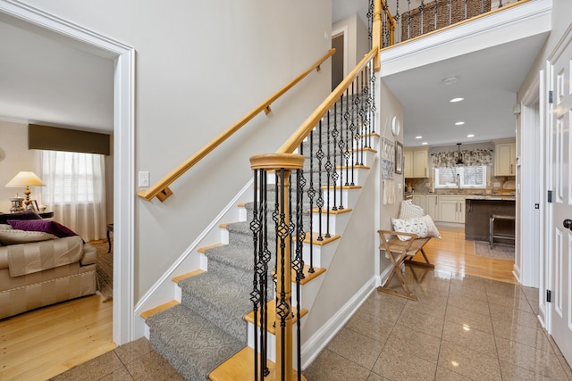 stairs featuring baseboards, granite finish floor, and recessed lighting