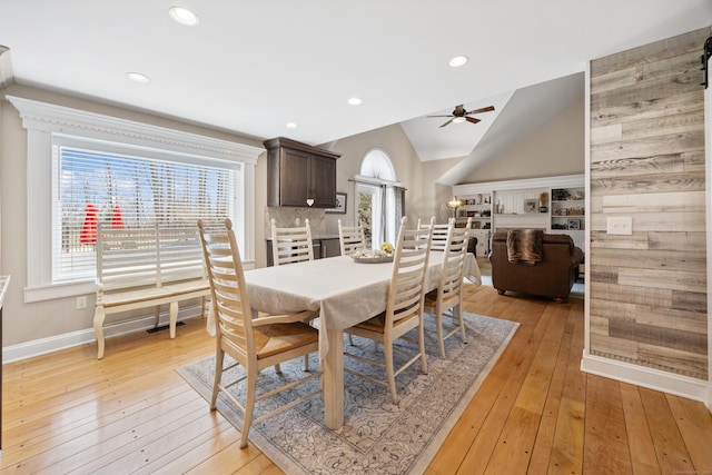 dining room with lofted ceiling, recessed lighting, baseboards, light wood finished floors, and ceiling fan