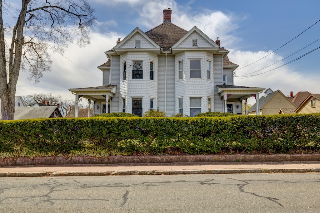 victorian house featuring a chimney