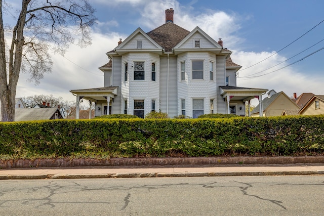 victorian house featuring a chimney