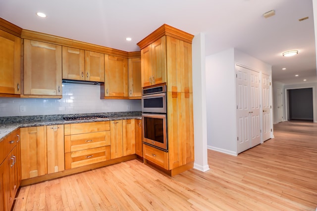73A Long Meadow Hill Rd, Brookfield, CT 06804 - kitchen with stainless steel appliances, light wood finished floors, stone countertops, backsplash, and baseboards