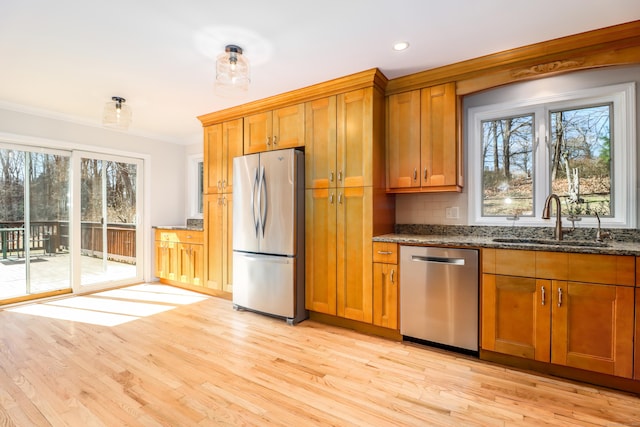 73A Long Meadow Hill Rd, Brookfield, CT 06804 - kitchen featuring stainless steel appliances, a sink, dark stone countertops, brown cabinetry, and light wood-style flooring