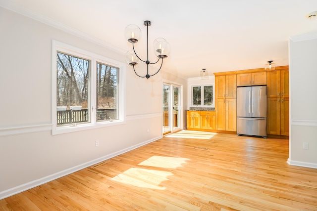 73A Long Meadow Hill Rd, Brookfield, CT 06804 - unfurnished dining area featuring ornamental molding, a chandelier, light wood finished floors, and baseboards