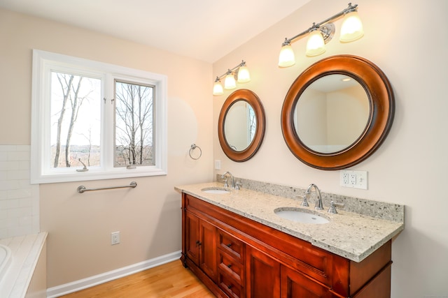 73A Long Meadow Hill Rd, Brookfield, CT 06804 - full bathroom with wood finished floors, double vanity, baseboards, and a tub
