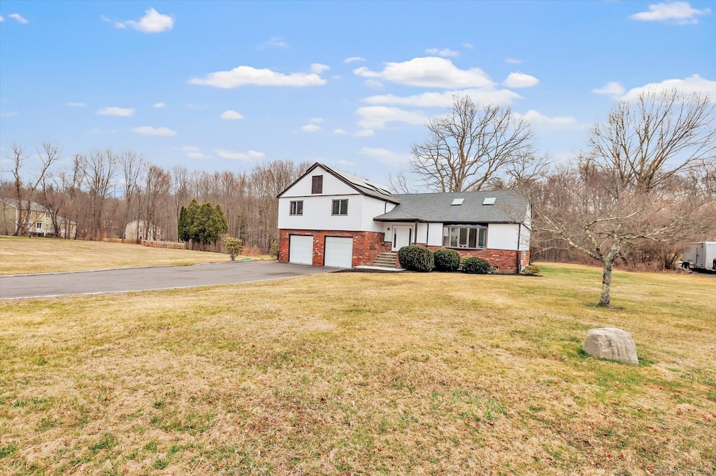 70 Georges Ln, Monroe, CT 06468 - split level home with roof with shingles, aphalt driveway, brick siding, a front yard, and a garage