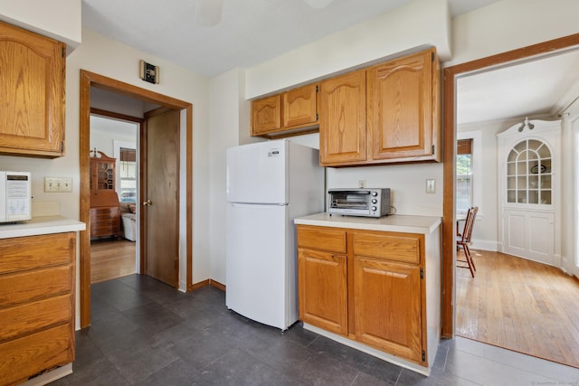 30 Phelps Rd, Manchester, CT 06042 - kitchen featuring white appliances, light countertops, and brown cabinetry