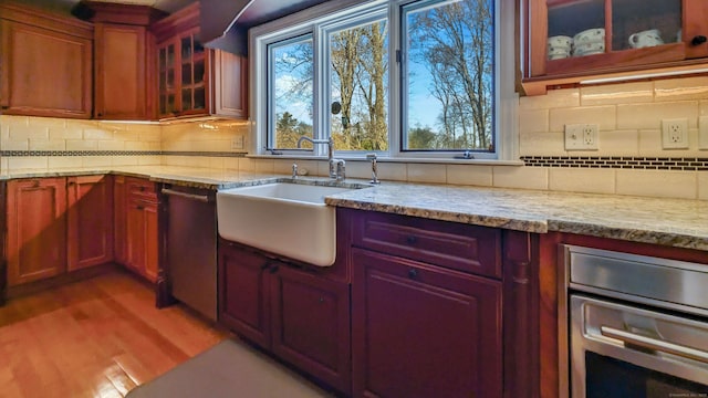 3 Mountain Dr, New Milford, CT 06776 - kitchen featuring light wood finished floors, decorative backsplash, a sink, and appliances with stainless steel finishes