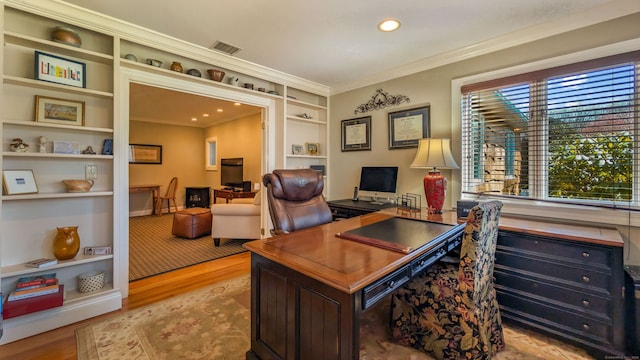3 Mountain Dr, New Milford, CT 06776 - home office featuring light wood-style flooring, crown molding, built in shelves, and visible vents