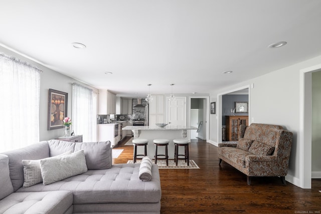 living room featuring dark wood-style flooring, recessed lighting, and baseboards
