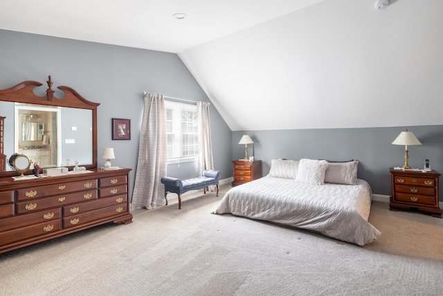 carpeted bedroom featuring vaulted ceiling and baseboards