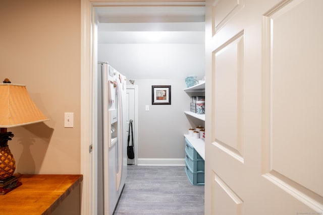 laundry area featuring baseboards and wood finished floors