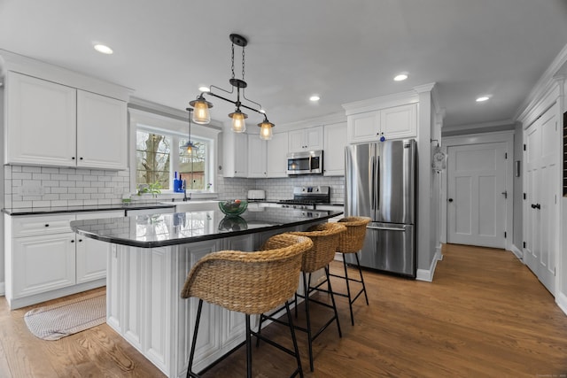 136 Tater Hill Rd, East Haddam, CT 06423 - kitchen featuring stainless steel appliances, dark countertops, white cabinetry, crown molding, and recessed lighting