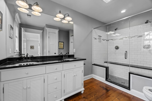 136 Tater Hill Rd, East Haddam, CT 06423 - bathroom featuring a shower stall, double vanity, wood finished floors, toilet, and recessed lighting