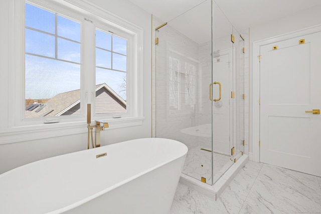 full bathroom featuring a marble finish shower, marble finish floor, and a freestanding tub