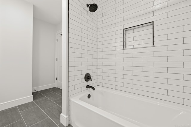 full bath with washtub / shower combination and baseboards