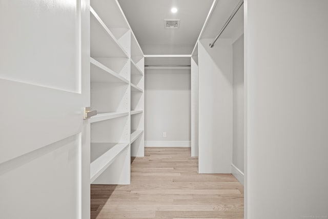 walk in closet with visible vents and light wood-type flooring