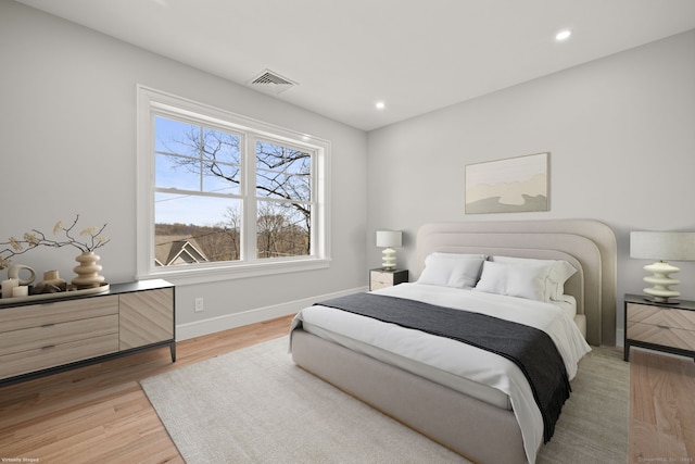 bedroom with visible vents, light wood-type flooring, recessed lighting, and baseboards