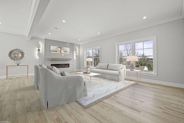 living room featuring recessed lighting, a large fireplace, light wood-style floors, and baseboards