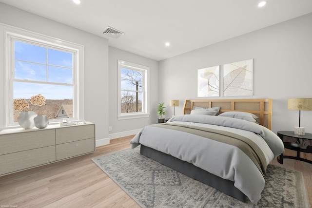 bedroom with baseboards, visible vents, light wood-style flooring, and recessed lighting