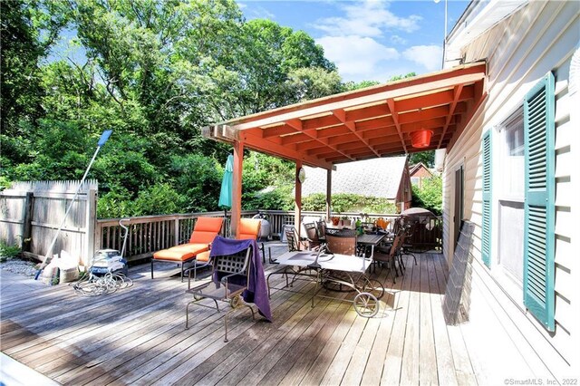 wooden deck featuring outdoor dining area