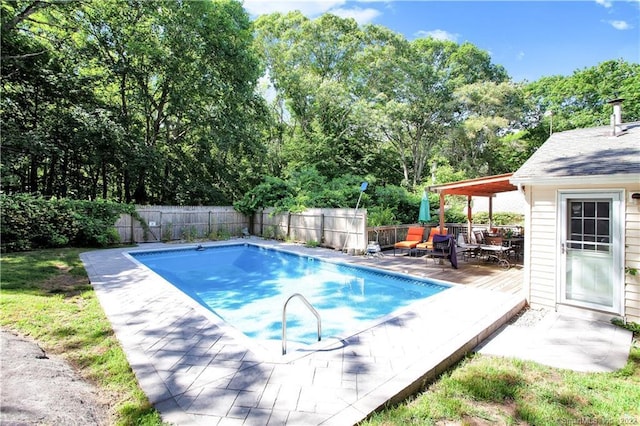 view of swimming pool with a deck, a fenced in pool, and a fenced backyard